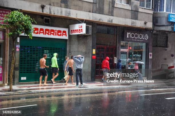 Group of young people walk in the rain on September 25 in Las Palmas de Gran Canaria, Canary Islands, Spain. The Government of the Canary Islands has...
