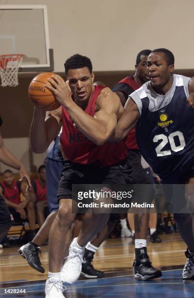 Tony Gonzalez of the Miami Heat is defended by Fred Jones of the Indiana Pacers during the Orlando Pro Summer League on July 10, 2002 at RDV...