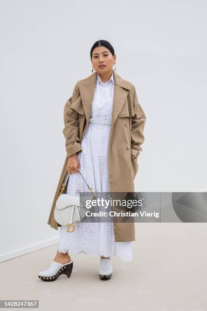 Princess of Thailand Sirivannavari Nariratana Rajakanya wears beige coat, white laced skirt and button shirt, bag outside Dior during Paris Fashion...