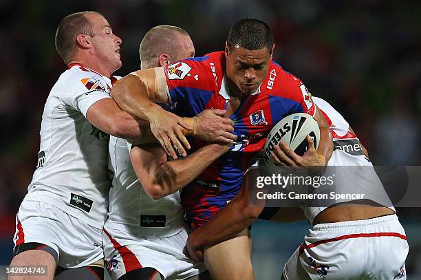 Timana Tahu of the Knights is tackled during the round seven NRL match between the St George Illawarra Dragons and the Newcastle Knights at WIN...