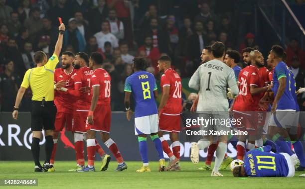 Dylan Bronn of Team Tunisia receive a red card by the referee Ruddy Buquet after a fault on Neymar Jr of Team Brazil during the friendly game between...