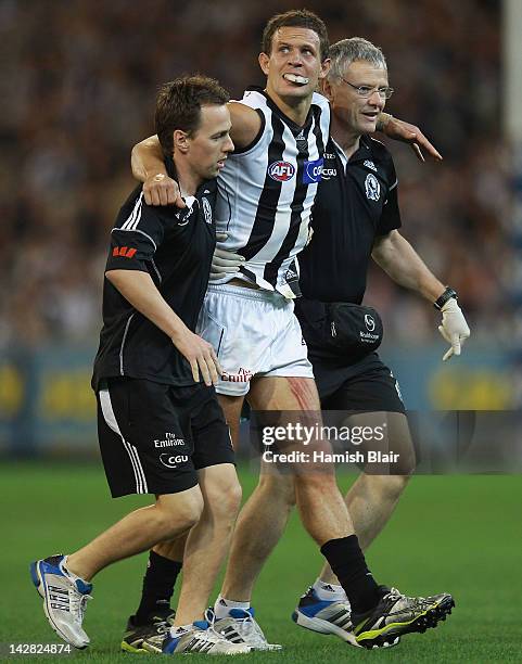 Luke Ball of the Magpies leaves the field with an injured knee during the round three AFL match between the Carlton Blues and the Collingwood Magpies...