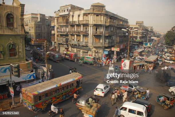 cars moving on road with buildings - karachi ストックフォトと画像