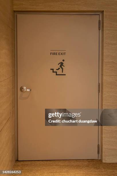 emergency exit door in the building - fire exit sign stock pictures, royalty-free photos & images