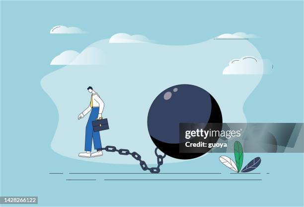 the man is chained by an iron ball. - ball and chain stock illustrations