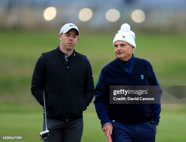 Jimmy Dunne of The United States the Vice Chairman of US Investment bank Piper Sandler talks with Rory McIlroy of Northern Ireland during a practice...