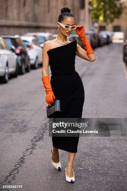 Anna Rosa Vitiello is seen wearing white sunglasses, a black tube dress, orange shiny leather high gloves, white and black pointed pumps heels shoes...