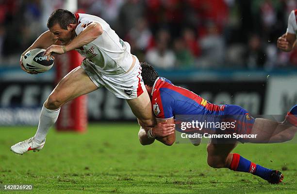 Brett Morris of the Dragon is tackled during the round seven NRL match between the St George Illawarra Dragons and the Newcastle Knights at WIN...