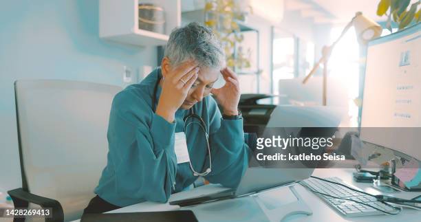 sad, headache or burnout doctor woman in office technology for telehealth stress, online problem or medical fail. tired, sad or frustrated senior nurse for mental health care risk and work management - paperwork frustration stock pictures, royalty-free photos & images