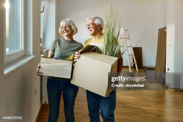 happy senior couple moving into a new home. - senior moving house stock pictures, royalty-free photos & images