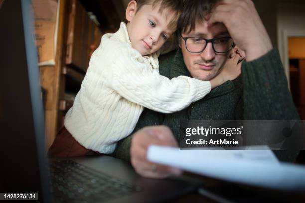 worried man and his son checking bills, frustrated about high prices and having financial problems - lagförslag bildbanksfoton och bilder