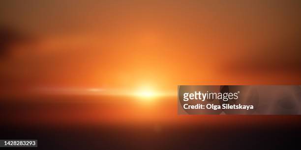 defocused sunrise or sunset - lense flare stock-fotos und bilder