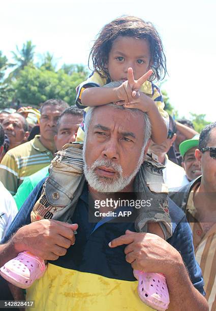 East Timor Prime Minister Xanana Gusmao carries a child as he campaigns for presidential candidate Taur Matan Ruak in Likisa on April 13, 2012. Ruak,...