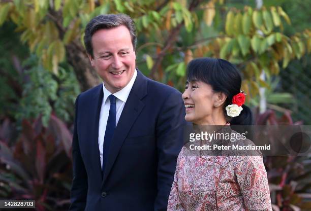 Prime Minister David Cameron walks with pro-democracy leader Aung San Suu Kyi in her garden on April 12, 2012 in Yangon, Myanmar. Mr Cameron is...