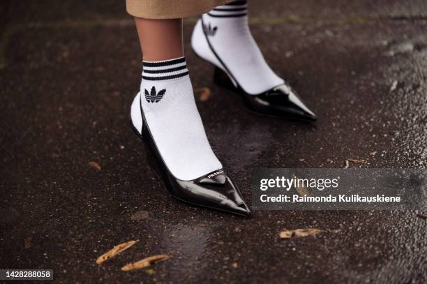 Guest wearing white Adidas socks, and black Prada shoes outside Victoria/Tomas, during Paris Fashion Week - Womenswear Spring/Summer 2023, on...