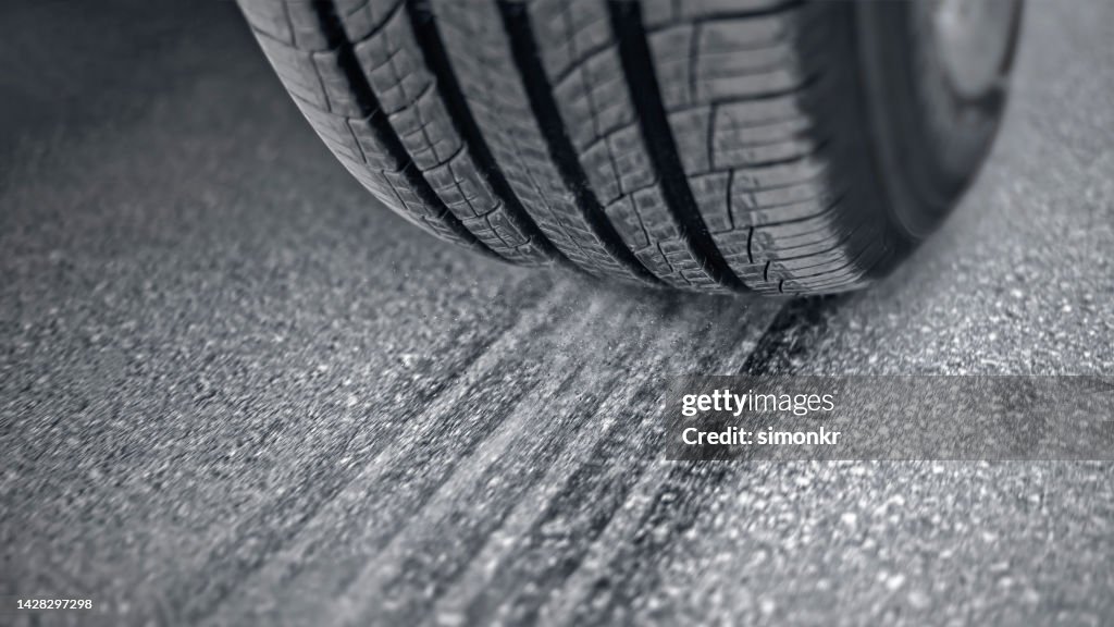 Tire of car driving on road