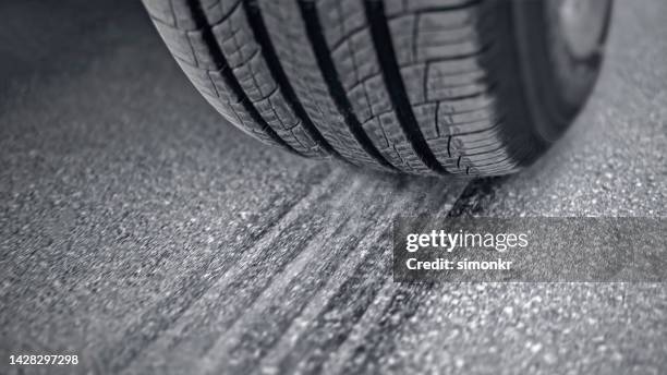 tire of car driving on road - tyre track stock pictures, royalty-free photos & images