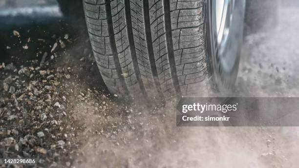 dust splashing from tire of car driving - car splashing stock pictures, royalty-free photos & images