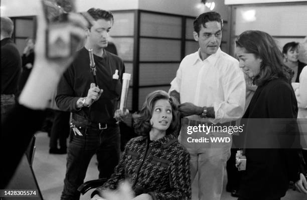 Hairstylist Oribe and assistant style model Christy Turlington's hair while Kelly Klein observes.