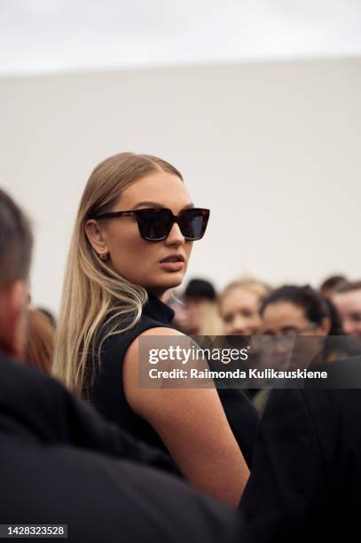 Romee Strijd wearing black mini dress, black sunglasses and black Dior bag outside Christian Dior, during Paris Fashion Week - Womenswear...