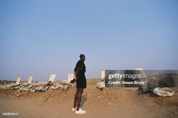 Zambia team captain Kalusha Bwalya pays his respects to the graves of the Zambian national football team members killed in an air crash on 12th July...