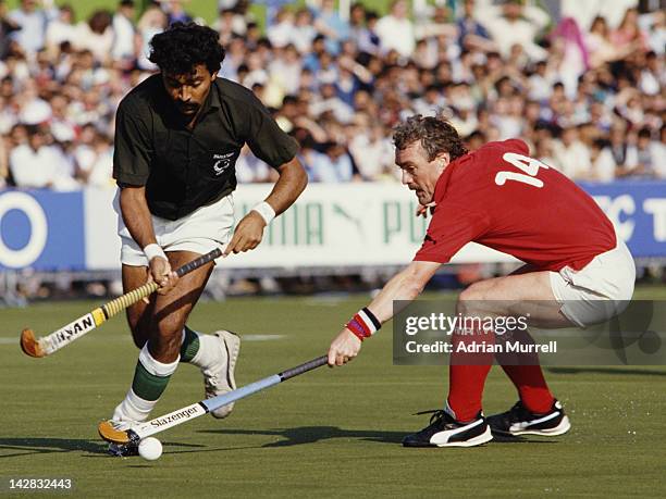 Abdul Rashid of Pakistan is tackled by Norman Hughes of England during their Pool A match at the 6th FIH Men's Field Hockey World Cup on 11th October...