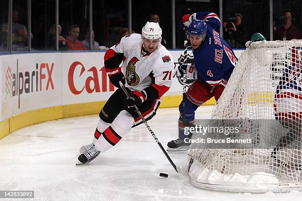 Nick Foligno of the Ottawa Senators skates with the puck behind the net against Michael Del Zotto of the New York Rangers in Game One of the Eastern...