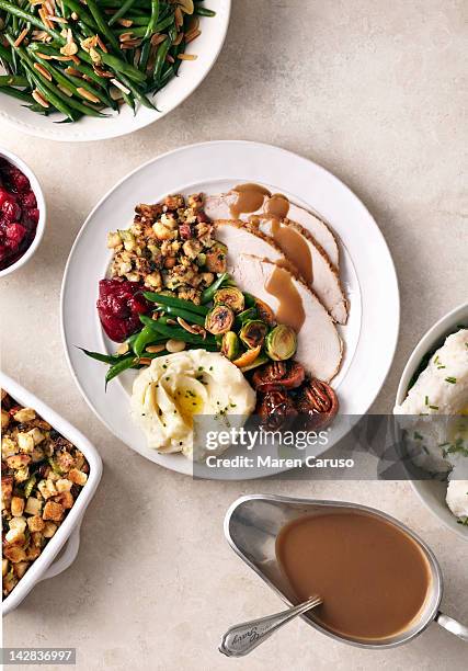 overhead of turkey meal on white surface - thanksgiving day stock-fotos und bilder