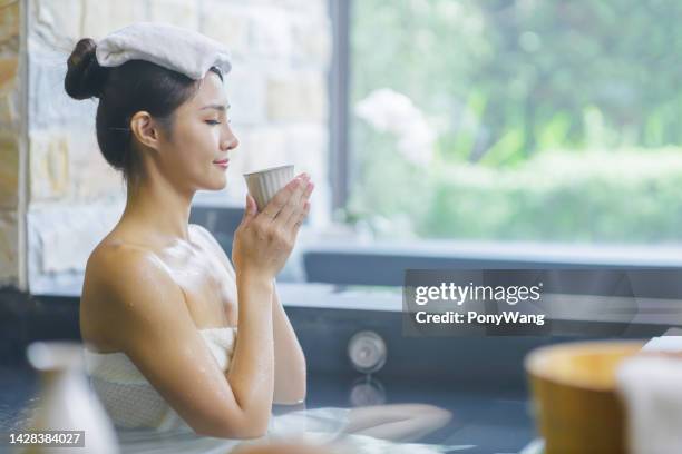 woman drink sake in water - winter skin stock pictures, royalty-free photos & images