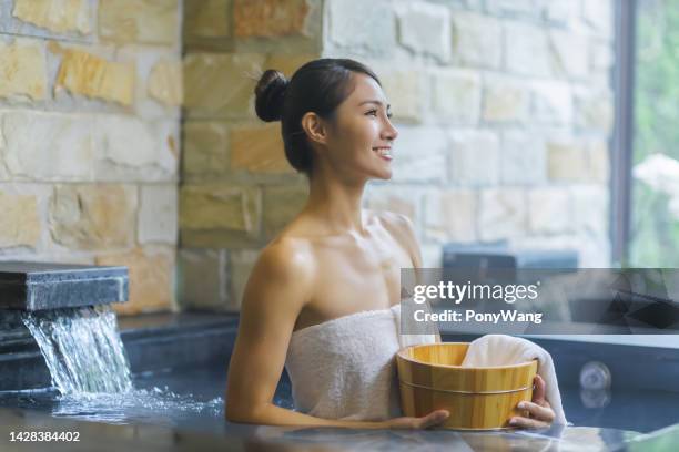 woman in hot spring relax - bath house stockfoto's en -beelden