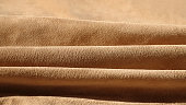 Suede leather waves close-up, texture of seamless sand leather