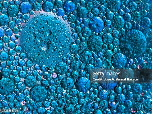 full frame of metallic texture thick liquid drops and bubbles. - blue swirls with bubbles stock pictures, royalty-free photos & images