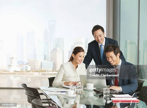 business people using laptop in meeting - chinese businessman stock pictures, royalty-free photos & images