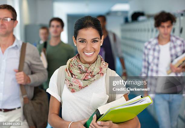 portrait of smiling university student in corridor - teacher with folder stock pictures, royalty-free photos & images