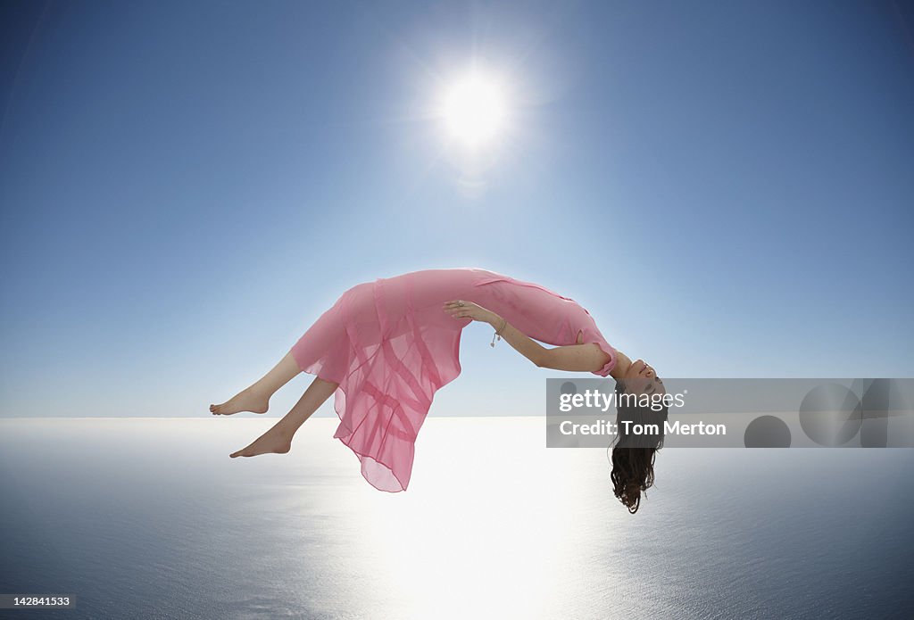 Woman floating over still ocean