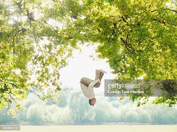 man doing a somersault in the woods - backflipping stock pictures, royalty-free photos & images