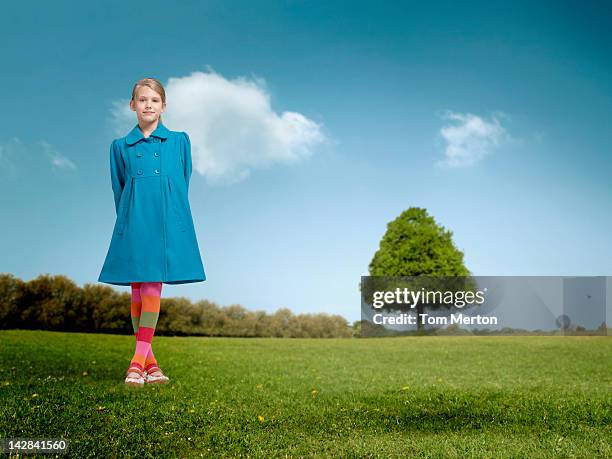 girl standing in rural field - girl in blue dress stock pictures, royalty-free photos & images