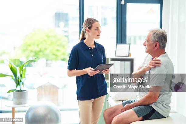 woman nurse, tablet and old man physiotherapy for shoulder pain, patient consultation and physical therapy. health, healthcare and senior retired man arm injury and therapist help on tech after fall. - physiotherapy stock pictures, royalty-free photos & images