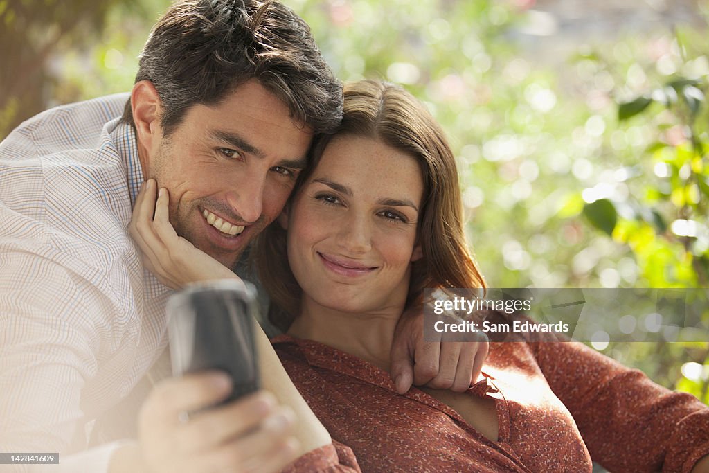 Smiling couple taking picture of themselves