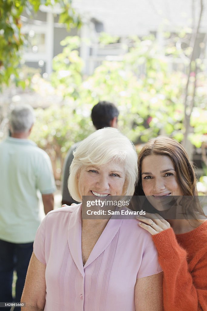 Mother and daughter smiling together outdoors