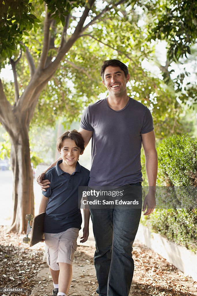 Father and son walking on suburban street