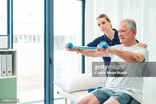 physiotherapy doctor, senior patient and band for stretching, physical therapy and orthopedic health. physiotherapist, chiropractor and nurse help elderly man, osteoporosis and surgery rehabilitation - groom human role stock pictures, royalty-free photos & images