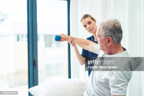 physiotherapist, medical exercise and senior man training at physiotherapy, support from physical therapy doctor and help after body injury. elderly patient doing healthcare fitness with nurse - sports training clinic 個照片及圖片檔