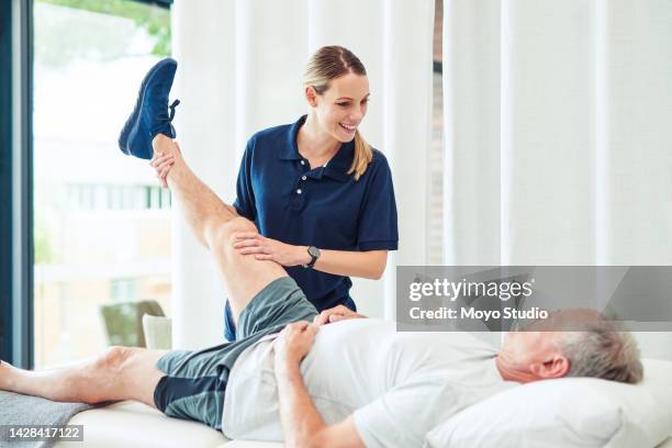 physiotherapist, training legs and senior man with support from physiotherapy nurse, help with physical therapy after injury and exercise with doctor. elderly man stretching with chiropractor - sports training clinic 個照片及圖片檔