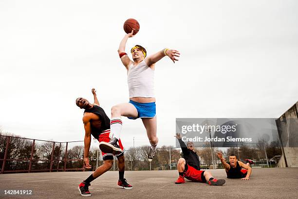 uncoordinated man winning a basketball game.. - intimidation stock pictures, royalty-free photos & images