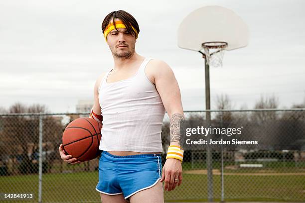 dork  standing with basketball under his arm. - headband stock-fotos und bilder