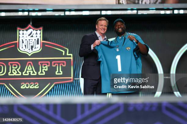 Commissioner Roger Goodell of the NFL presents number one pick Travon Walker of the Jacksonville Jaguars in the NFL football draft during round one...