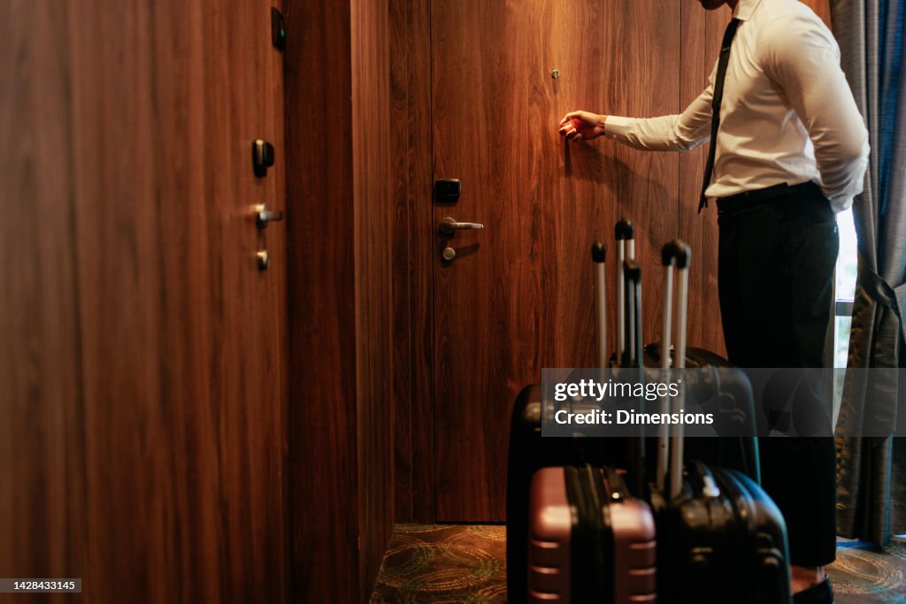 Hotel attendant ringing on guest doorbell.