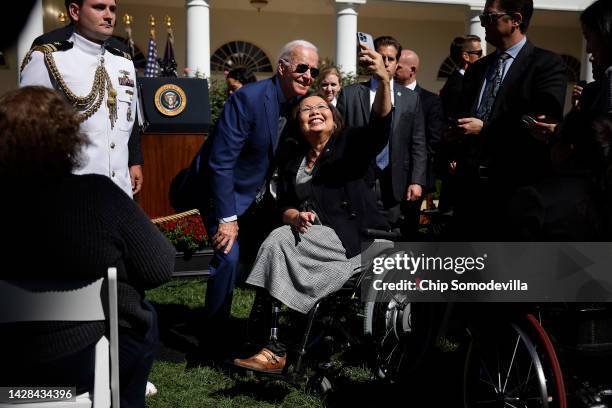 President Joe Biden poses for a selfie with Sen. Tammy Duckworth during a celebration of the 1990 passage of the Americans with Disabilities Act in...