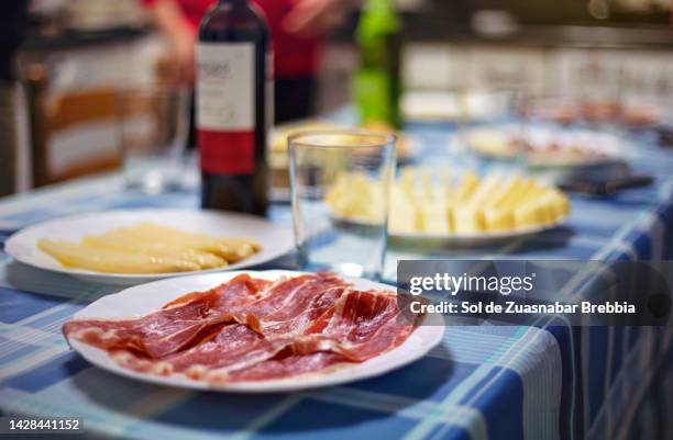 plate of raw cured ham on a table - jamón serrano fotografías e imágenes de stock